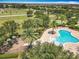 Aerial view showcasing community pool, playground, and park with mature trees at 11868 Thatcher Ave, Orlando, FL 32836