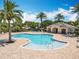 Community pool and lounge area with palm trees and ample seating at 11868 Thatcher Ave, Orlando, FL 32836