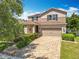 Two-story home showcasing a brick driveway, well-maintained landscaping, and a welcoming front entrance at 11868 Thatcher Ave, Orlando, FL 32836