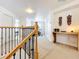 Upstairs hallway featuring a wooden railing and unique decorations at 11868 Thatcher Ave, Orlando, FL 32836