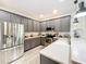 Well-lit kitchen featuring gray cabinets, stainless steel appliances, and a breakfast bar at 11868 Thatcher Ave, Orlando, FL 32836