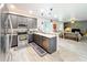 Spacious kitchen open to living room with stainless steel appliances and ample counter space at 11868 Thatcher Ave, Orlando, FL 32836