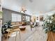 Spacious living room and dining area featuring modern decor, neutral color palette, and warm lighting at 11868 Thatcher Ave, Orlando, FL 32836