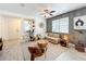 Comfortable living room featuring modern furnishings, plants, neutral colors, and plenty of natural light at 11868 Thatcher Ave, Orlando, FL 32836