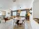 Bright living room and dining room area featuring wood-look tile flooring and modern decor at 11868 Thatcher Ave, Orlando, FL 32836