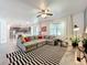 Open living area featuring a large sectional sofa, kitchen, and dining area at 11868 Thatcher Ave, Orlando, FL 32836