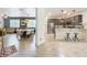 Open concept living spaces with wood-look tile flooring, including the living room, dining area, and kitchen at 11868 Thatcher Ave, Orlando, FL 32836