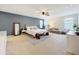 Spacious primary bedroom features neutral paint and a decorative accent wall at 11868 Thatcher Ave, Orlando, FL 32836
