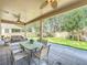 Covered patio boasts ceiling fans, and an outdoor dining area, perfect for entertaining at 11868 Thatcher Ave, Orlando, FL 32836