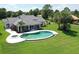 Aerial view of the pool, lanai, and the beautifully landscaped backyard at 12508 Lake Denise Blvd, Clermont, FL 34711
