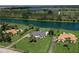 Expansive aerial view of a luxurious home, highlighting its beautifully landscaped yard and waterfront access to the lake at 12508 Lake Denise Blvd, Clermont, FL 34711
