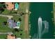 Stunning aerial view of a luxury home with private pool and lake access, featuring a boat on the water at 12508 Lake Denise Blvd, Clermont, FL 34711