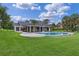 Lush backyard featuring a sparkling pool and screened-in lanai at 12508 Lake Denise Blvd, Clermont, FL 34711