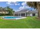 Expansive backyard with well-manicured lawn, pool, and screened patio at 12508 Lake Denise Blvd, Clermont, FL 34711