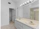 Bright bathroom features double sinks, large mirror, shower, and a separate toilet area at 12508 Lake Denise Blvd, Clermont, FL 34711