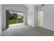 Bedroom featuring a sliding glass door to the backyard, plush carpeting, and an ensuite bathroom at 12508 Lake Denise Blvd, Clermont, FL 34711