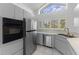 Bright kitchen features stainless steel appliances, white cabinets, and a window above the sink at 12508 Lake Denise Blvd, Clermont, FL 34711