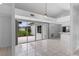 Bright living room with tile floors and sliding doors leading to the backyard, seamlessly connecting indoor and outdoor spaces at 12508 Lake Denise Blvd, Clermont, FL 34711