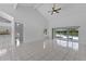 Bright and airy living room with tile floors, vaulted ceilings, and sliding glass doors to the backyard at 12508 Lake Denise Blvd, Clermont, FL 34711