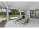 Screened-in patio with comfortable lounge chairs and views of manicured lawn at 12508 Lake Denise Blvd, Clermont, FL 34711