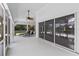 Relaxing screened-in patio with lounge chairs and view of lush landscaping at 12508 Lake Denise Blvd, Clermont, FL 34711
