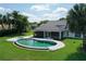 Beautiful backyard pool with a screened patio and lush green lawn, perfect for outdoor relaxation at 12508 Lake Denise Blvd, Clermont, FL 34711