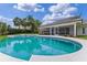 Sparkling pool surrounded by lush landscaping and a screened-in lanai at 12508 Lake Denise Blvd, Clermont, FL 34711