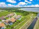 An aerial view of beautiful homes with red tile roofs near a lake and natural surroundings at 13791 Abberwick Dr, Orlando, FL 32832
