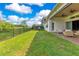 Spacious backyard with lush green lawn, outdoor seating, and a trampoline for recreation at 13791 Abberwick Dr, Orlando, FL 32832