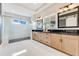 Modern bathroom with a glass shower, double sink vanity, and sleek fixtures at 13791 Abberwick Dr, Orlando, FL 32832