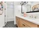 Elegant bathroom featuring double sinks, quartz counters, and black and white tiled floor at 13791 Abberwick Dr, Orlando, FL 32832