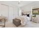 Cozy bedroom features a large window, neutral bedding, and chair at 13791 Abberwick Dr, Orlando, FL 32832