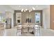 Charming dining room area with a light wood table, modern wallpaper and view to the exterior at 13791 Abberwick Dr, Orlando, FL 32832
