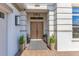 Inviting front entrance featuring a double wood door, brick walkway, and potted plants at 13791 Abberwick Dr, Orlando, FL 32832