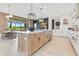 Bright, open kitchen with custom wood cabinets, stone countertops, and stainless steel appliances at 13791 Abberwick Dr, Orlando, FL 32832