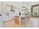 Modern kitchen featuring white cabinets, stainless steel appliances, and an island with bar seating at 13791 Abberwick Dr, Orlando, FL 32832