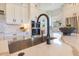 Modern kitchen featuring granite countertops, stainless steel sink and appliances and custom backsplash at 13791 Abberwick Dr, Orlando, FL 32832
