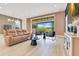 Open living room boasting hardwood floors, stylish furniture, and sliding glass doors to the patio at 13791 Abberwick Dr, Orlando, FL 32832