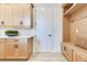Mudroom features built-in storage cabinets and bench with light wood tones and contrasting hardware at 13791 Abberwick Dr, Orlando, FL 32832