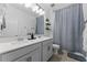 Bathroom featuring gray vanity with dual sinks, decorative mirror, and a shower/tub combo at 1425 Paget Cv, Sanford, FL 32771