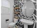 Stylish bathroom with modern patterned wall, floating shelves, pedestal sink and a round mirror at 1425 Paget Cv, Sanford, FL 32771