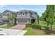 Charming two-story home features a well-manicured lawn and an inviting entrance with a brick driveway at 1425 Paget Cv, Sanford, FL 32771