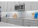 Modern kitchen featuring quartz countertops, stainless steel microwave, and a stylish backsplash at 1425 Paget Cv, Sanford, FL 32771