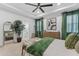 A main bedroom featuring neutral tones, a large potted plant, and ensuite bathroom at 1425 Paget Cv, Sanford, FL 32771