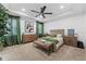 Bright main bedroom featuring tray ceilings, neutral tones, and green accents at 1425 Paget Cv, Sanford, FL 32771