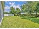 Picture of the beautifully maintained backyard with lush green grass and mature trees at 14325 Hidden Ct, Clermont, FL 34711