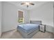 Cozy bedroom offers a comfortable and well-lit space with a gray bed frame and matching dresser at 14325 Hidden Ct, Clermont, FL 34711
