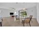 Bright dining area with tile flooring and access to the screened lanai at 14325 Hidden Ct, Clermont, FL 34711