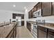 Well-equipped kitchen features stainless steel appliances and granite countertops at 14325 Hidden Ct, Clermont, FL 34711
