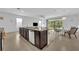 Open kitchen with granite countertops, stainless steel appliances, and a view of the living area at 14325 Hidden Ct, Clermont, FL 34711